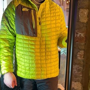 Yellow North Face jacket with gray patch